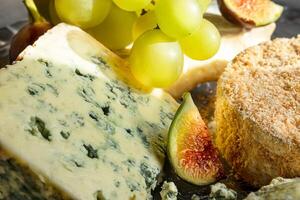 Assortment of French cheese with grapes photo