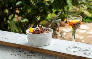 A bowl with chocolate mousse and liqueur photo