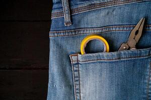 Work tools in a jeans pocket photo