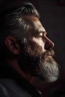 Portrait of serious beard man in low key light side view image photo