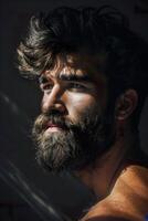 Portrait of serious beard man in low key light side view image photo