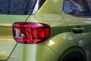 Rear running lights of Hyundai Venue green apple car close-up. Ukraine, Kyiv, April 10, 2024 photo