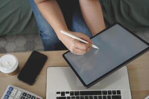 person using digital tablet in office photo