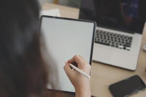 person using digital tablet in office photo