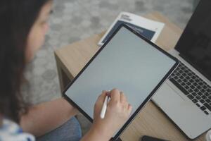 person using digital tablet in office photo