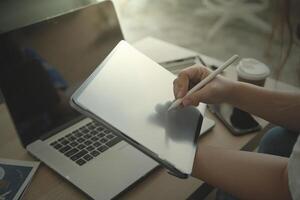 person using digital tablet in office photo