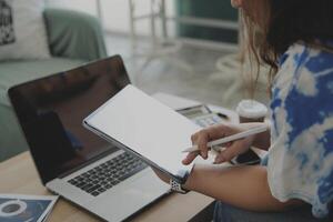 person using digital tablet in office photo