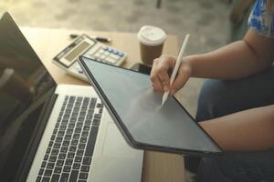 person using digital tablet in office photo