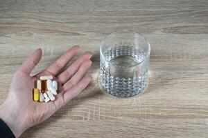 A large amount of pills and capsules - daily supplementation photo