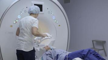 The patient girl gets up after studying the magnetic resonance imaging video