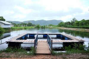 Natural freshwater fish farming cages in Thailand photo