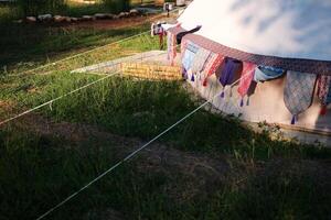 Vintage Glamping tent ropes on grass ground in camping area photo