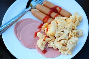 Breakfast with delicious ham with sausage and egg omelet, Scrambled eggs photo