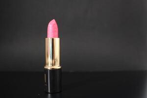 Pink lipstick in a black tube photo