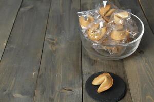 Chinese biscuits on a stand on a gray background with prediction text. Chinese New Year traditions. Copyspace photo