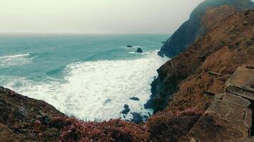 View from the cliff to the stormy ocean in cloudy weather. Rocky coast of the Pacific Ocean near San Francisco on a cloudy day video