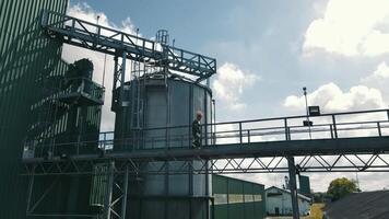 agronomist farmer checking grain, soybean and wheat storage tanks. video