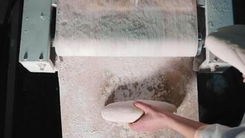 Artisan Dough Shaping, Hands shaping loaves on a floured surface in bakery. video