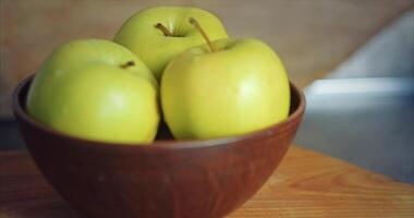 Three green apples in a deep clay plate video