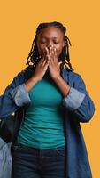 Vertical African american woman covering eyes, ears and mouth with hands, imitating the three wise monkeys. Girl doing do not see, do not hear and do not speak gesturing concept, studio background, camera B video