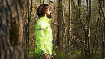 Rescue squad leader guiding route through the woods to collect evidence during searching operation to locate missing person. Shouting individual's name, civil disappeared in a forest. Camera A. video