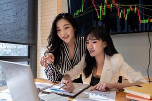 Group of Businesswoman and Accountant checking data document on digital tablet for investigation of corruption account . Anti Bribery concept. photo