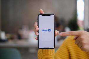 CHIANG MAI, THAILAND. MAY 03, 2021 . LinkedIn logo on phone screen. LinkedIn is a social network for search and establishment of business contacts. It is founded in 2002 photo