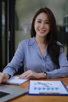 Photo of gorgeous secretary working at office. she sitting at the wooden desk.