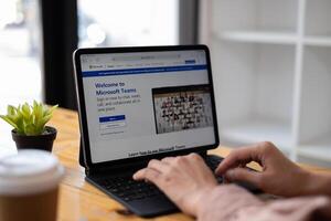 CHIANG MAI, THAILAND - Mar 21, 2021 . Business woman using Microsoft Teams social platform on tablet, ready for remote working in isolation from home. photo