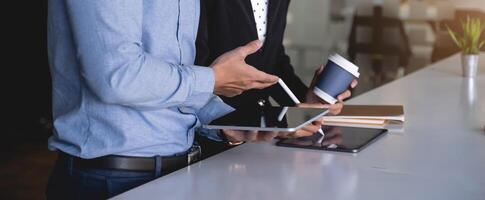 Group of Business man and Accountant checking data document on digital tablet for investigation of corruption account . Anti Bribery concept. photo