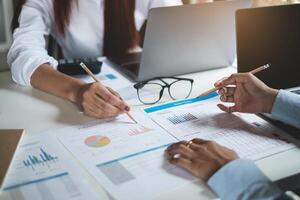 Group of Businesswoman and Accountant checking data document on paperwork for investigation of corruption account . Anti Bribery concept. photo