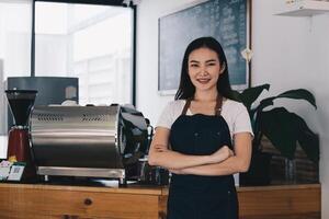 At her cafe, the business owner or barista is taking orders from customers. photo