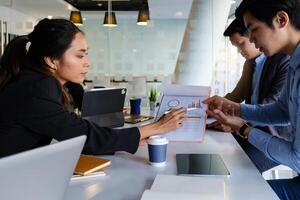 Group of Businessman and Accountant checking data document on digital tablet for investigation of corruption account . Anti Bribery concept. photo