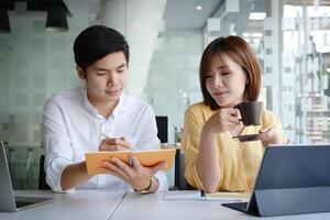 Group of Businesswoman and Accountant checking data document on digital tablet for investigation of corruption account . Anti Bribery concept. photo