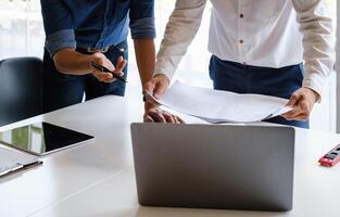 Two Architect man working with laptop and blueprints for architectural plan, engineer sketching a construction project concept. photo