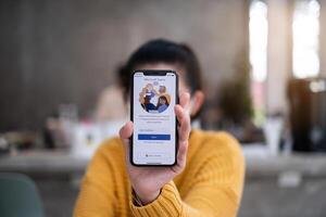 CHIANG MAI, THAILAND - APR 14, 2021 . A working from home employee is downloading the Microsoft Teams social platform. photo