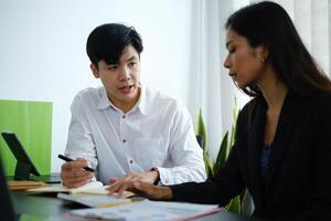 Businessman and team wear mask and try to explain about his work at home office. Work from home concept photo