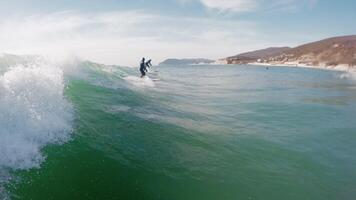 Surfer ride on ocean wave. First-person view of surfing in ocean video