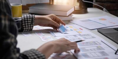 A close-up of an ux ui developer and an ui designer working on a mockup icon interface for a mobile app. photo