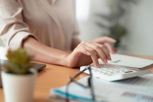 Administrator accountant making report calculating balance. Audit and Anti Bribery concept. photo