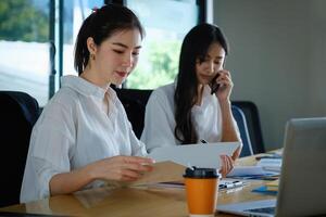 Two of Young business female working together and partners talking with customer. photo