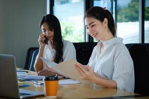 Two of Young business female working together and partners talking with customer. photo