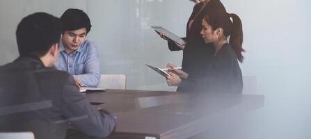 Group of Businesswoman and Accountant checking data document on digital tablet for investigation of corruption account . Anti Bribery concept. photo
