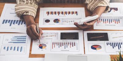A businessman examines a financial report in paperwork, data from the company's operations, and the notion of a balance sheet. photo