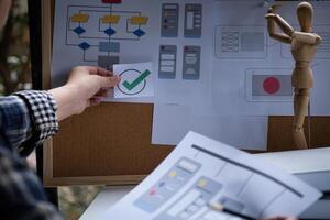 A close-up of an ux ui developer and an ui designer working on a mockup icon interface for a mobile app. photo