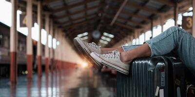 Alone traveler tourist walking with luggage at train station. work and travel lifestyle concept. photo