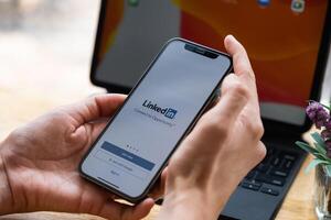 CHIANG MAI, THAILAND. Mar 20, 2021. LinkedIn logo on phone screen. LinkedIn is a social network for search and establishment of business contacts. It is founded in 2002. photo