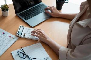 Administrator accountant making report calculating balance. Audit and Anti Bribery concept. photo