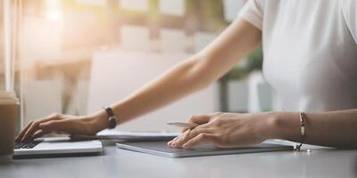 Fashion designer holding stylus pen and using digital tablet and drawing human figure sketches while working at wooden desk in home office. photo