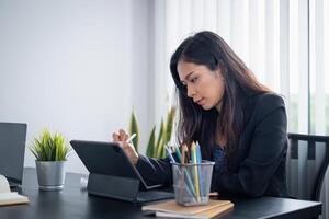 Female ux developer and ui designer sketching interface app in digital tablet in living room at home. Creative digital development agency concept. photo